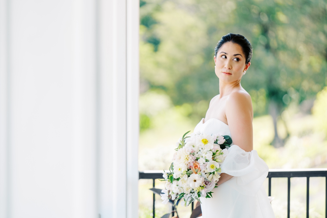 Close-up of Suzie’s bouquet with lush florals, complementing her timeless wedding day look.