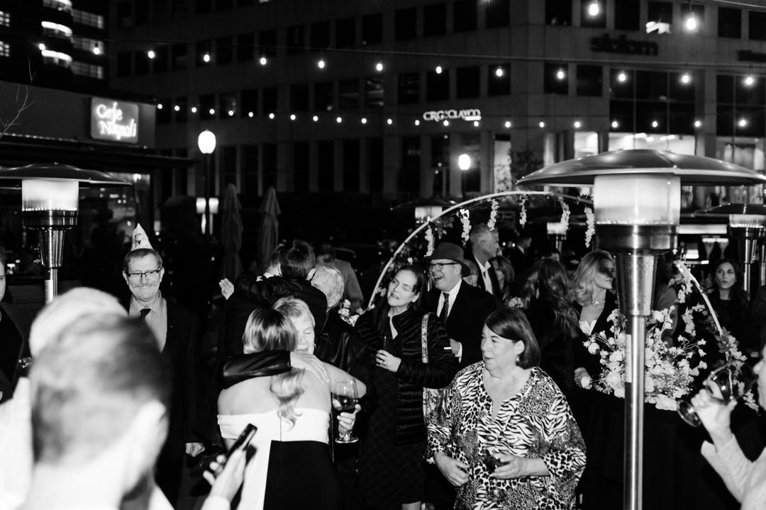 Gracie and Eric's mom, hugging surrounded by loved ones.