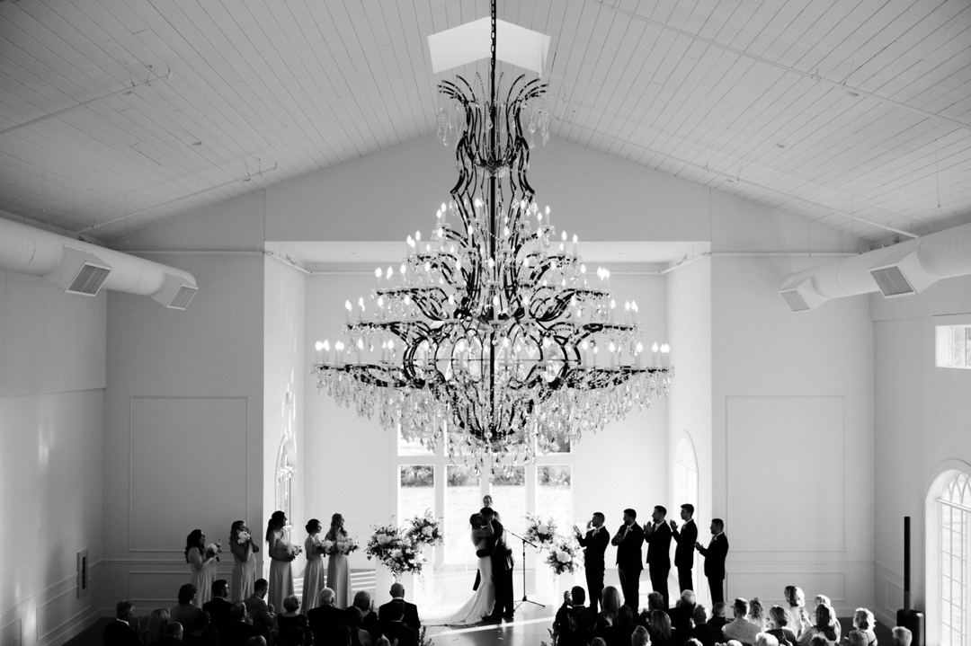 Elegant indoor ceremony at Westwind Hills with navy and champagne wedding colors.