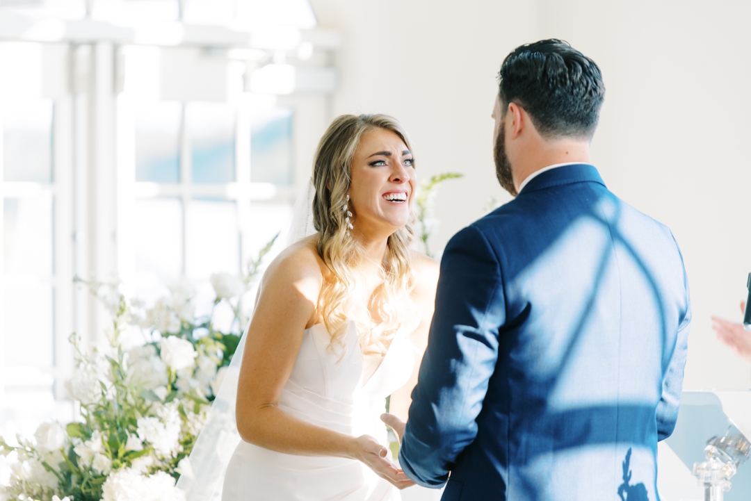Elegant indoor ceremony at Westwind Hills with navy and champagne wedding colors.
