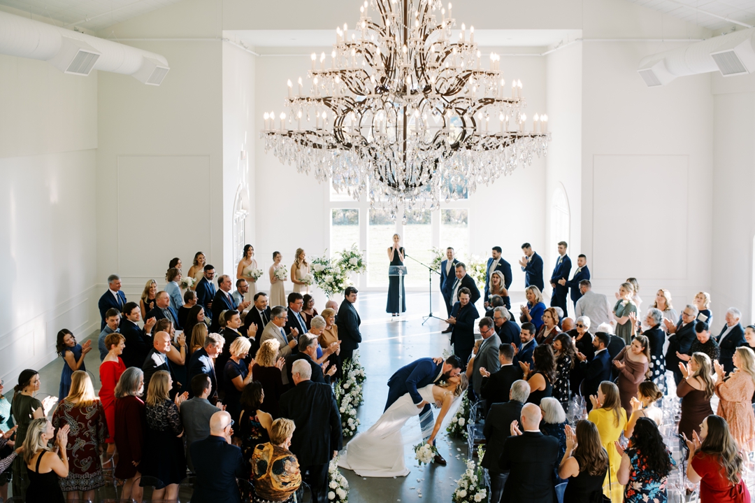 Wide-angle view of the indoor ceremony space at Westwind Hills, featuring navy and champagne decor accents.