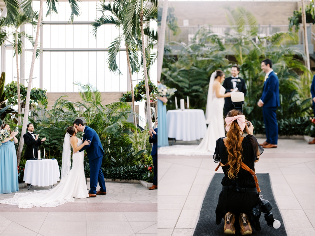 A couple exchanging vows inside The Jewel Box under its stunning glass structure.