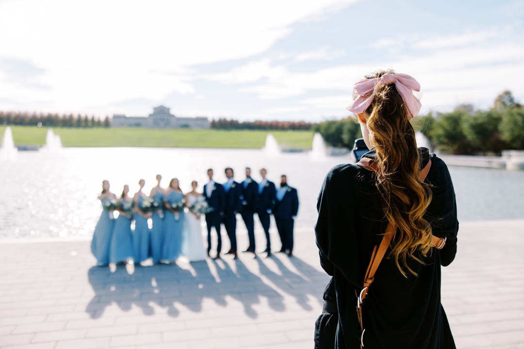 Bridal party poses at The Grand Basin with the St. Louis Art Museum in the background.