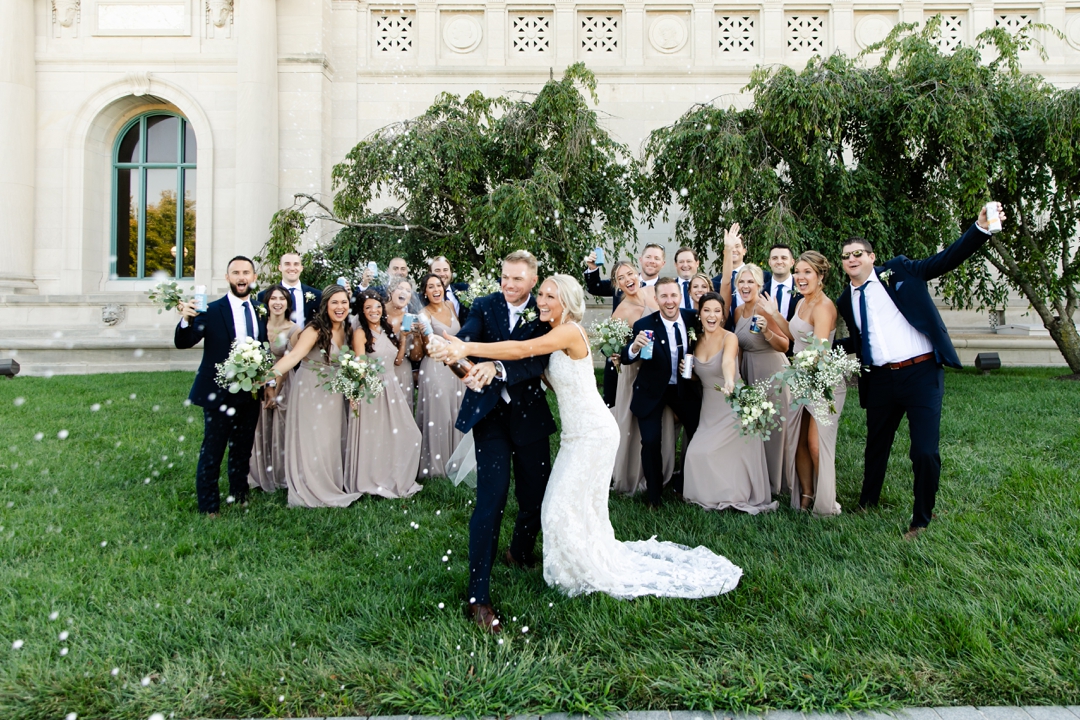 Wedding party champaign pop in front of the Saint Louis Art Museum