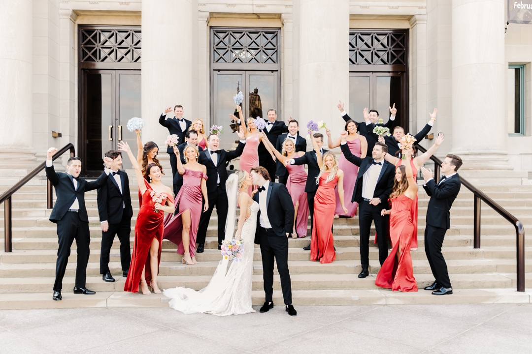 Elegant wedding party gathered on the steps of the Saint Louis Art Museum, blending timeless architecture with modern style.