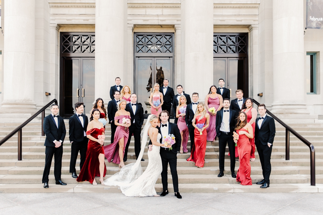 Vibrant wedding party photo with the grand facade of the Saint Louis Art Museum as the backdrop.