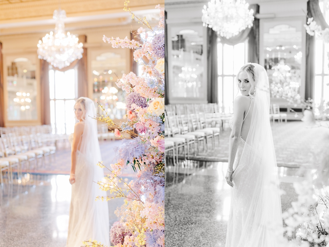 Bride Deane posing elegantly in front of vibrant spring florals at the Missouri Athletic Club.