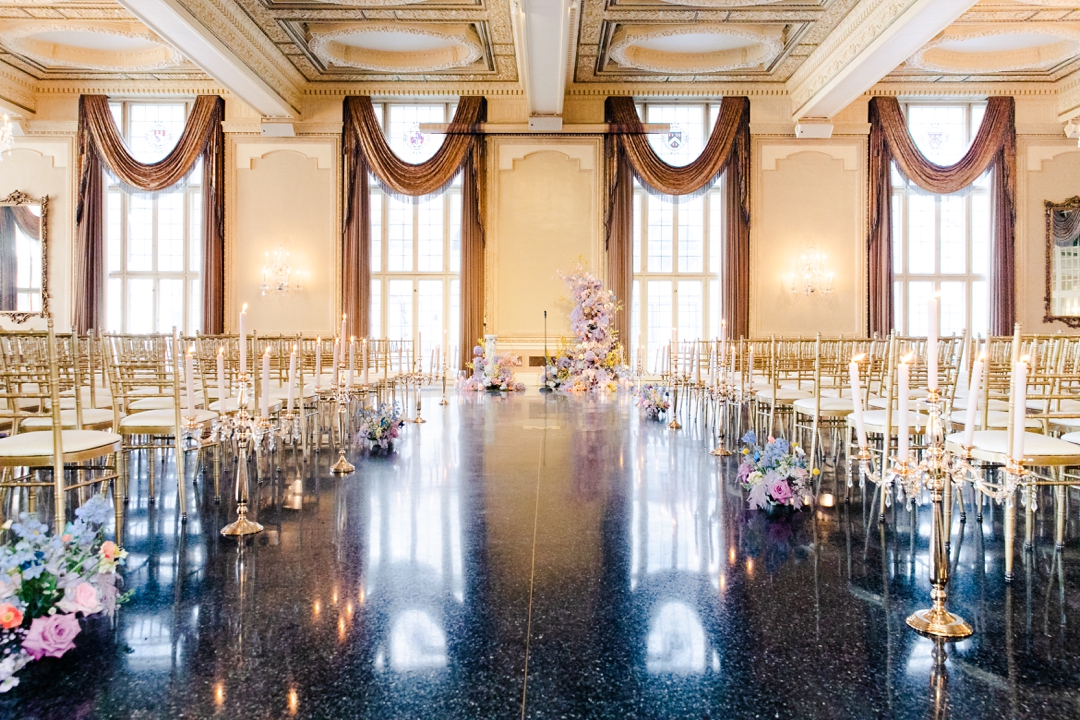 Intricate butterfly décor and lush flowers creating a whimsical atmosphere for Deane and Jeff’s ceremony.