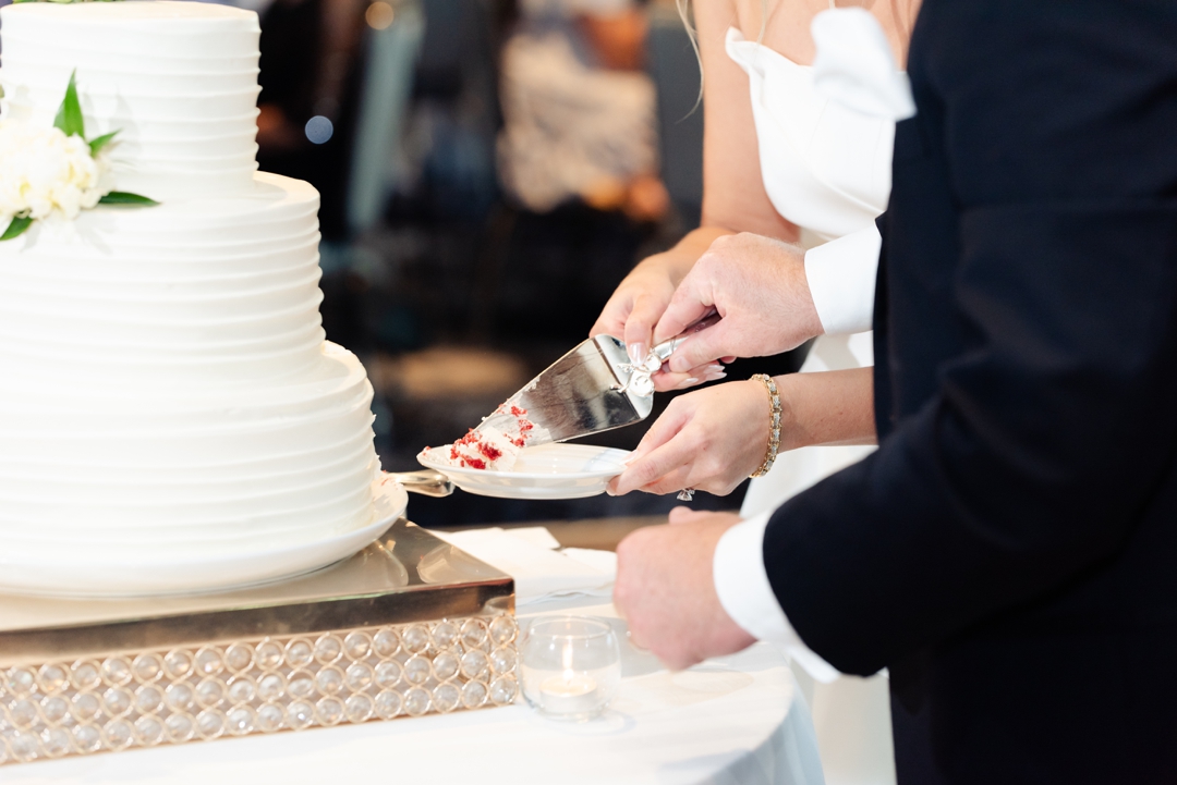 Bride Amanda and groom Mike cutting their wedding cake during the reception at The Chase Park Plaza.