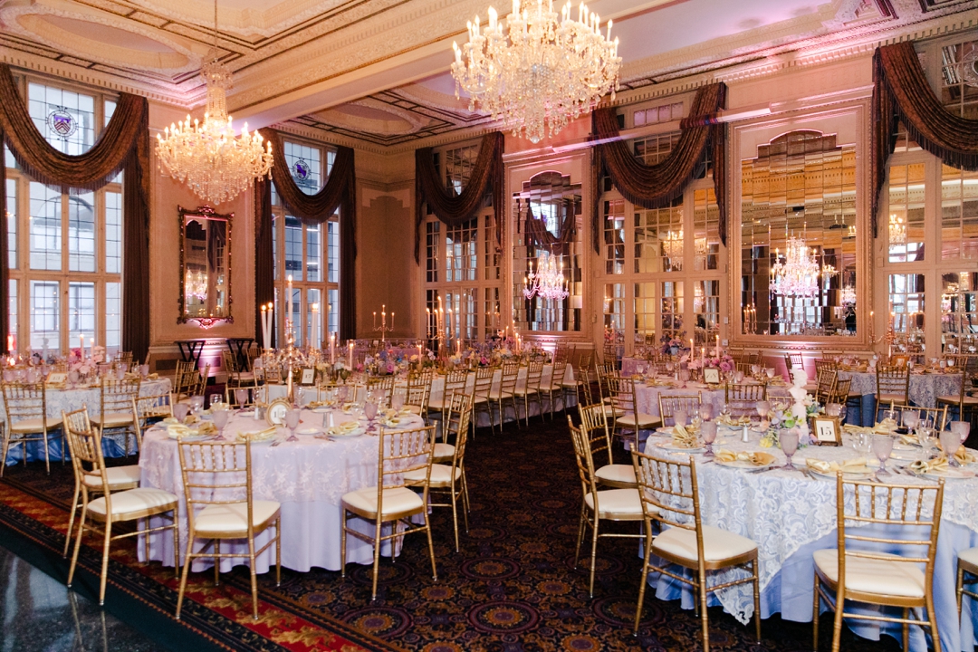 Wide shot of the reception space showcasing colorful florals, candles, and whimsical décor at Deane and Jeff’s wedding.