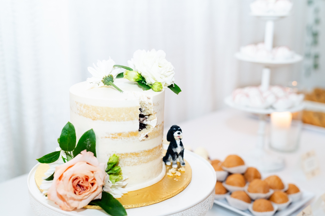 Close-up of the dessert bar featuring a small wedding cake with a whimsical Bear cake topper
