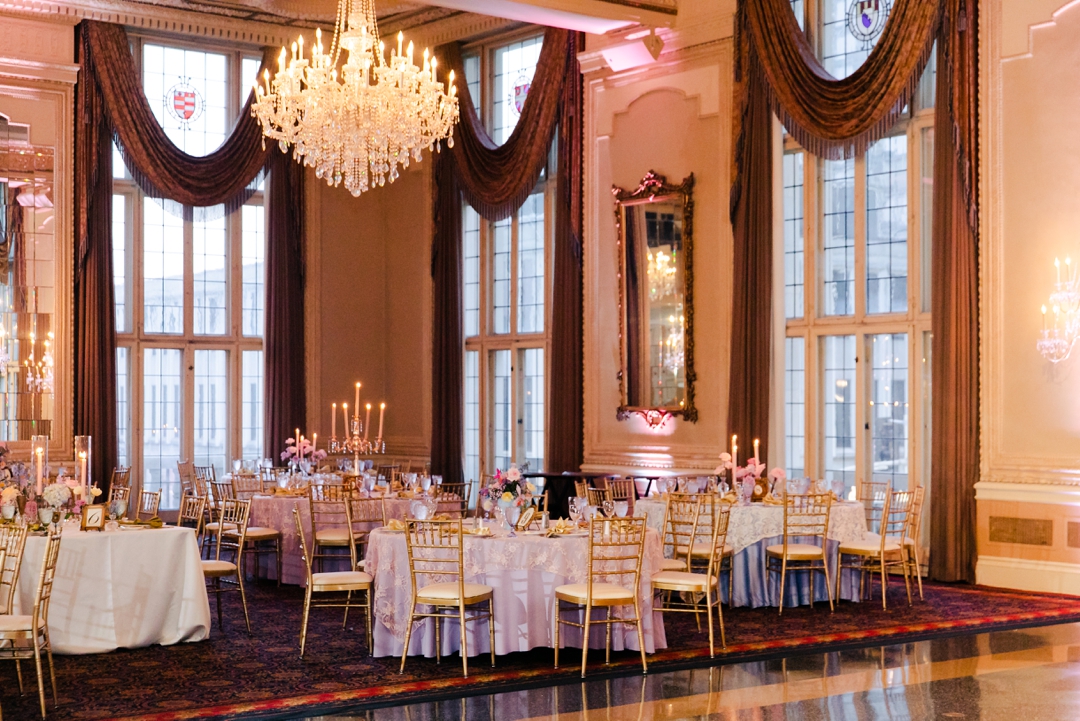 Wide shot of the reception space showcasing colorful florals, candles, and whimsical décor at Deane and Jeff’s wedding.
