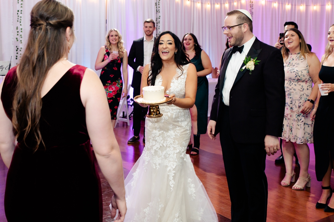 Guests singing Happy Birthday to Allie and Nate’s friend on the dance floor during the reception.