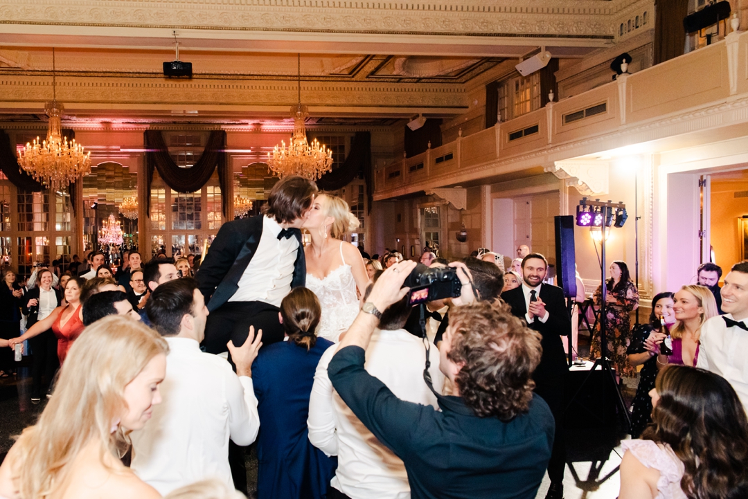Lively wedding guests enjoying the music on the packed dance floor during Deane and Jeff’s reception.