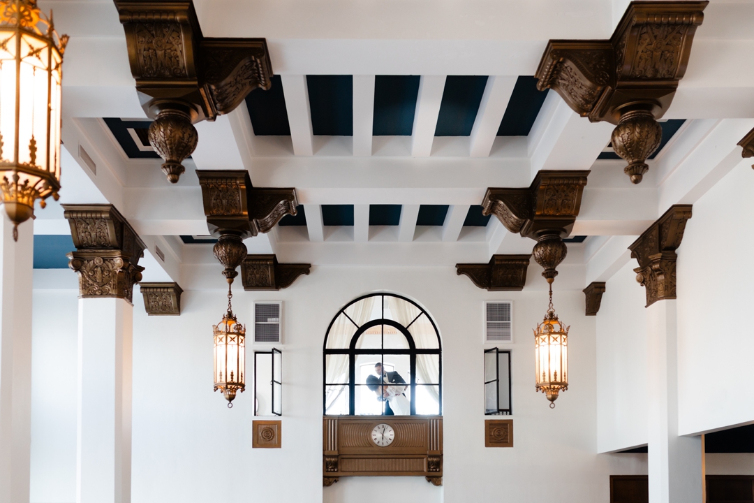 The Noble St. Louis wedding venue with soaring vaulted ceilings and large Art Deco windows, creating a dramatic backdrop for a luxury wedding.