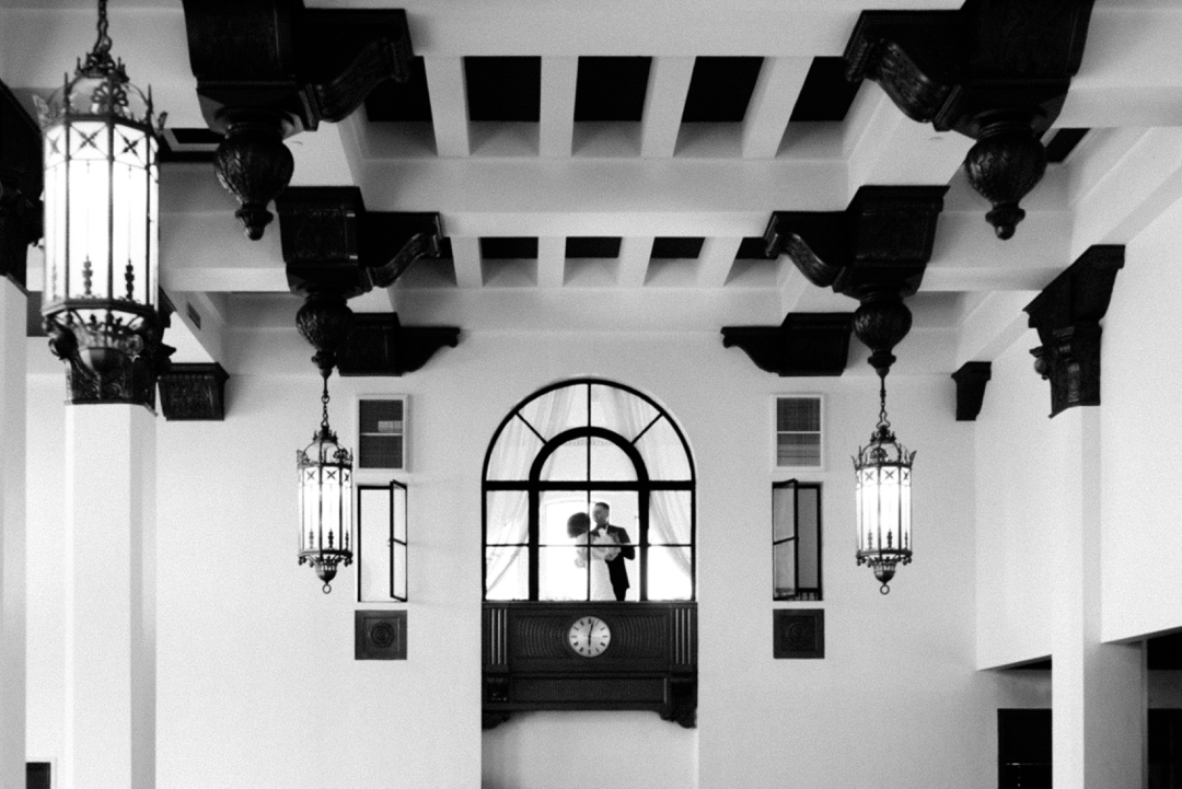 The Noble St. Louis wedding venue with soaring vaulted ceilings and large Art Deco windows, creating a dramatic backdrop for a luxury wedding.