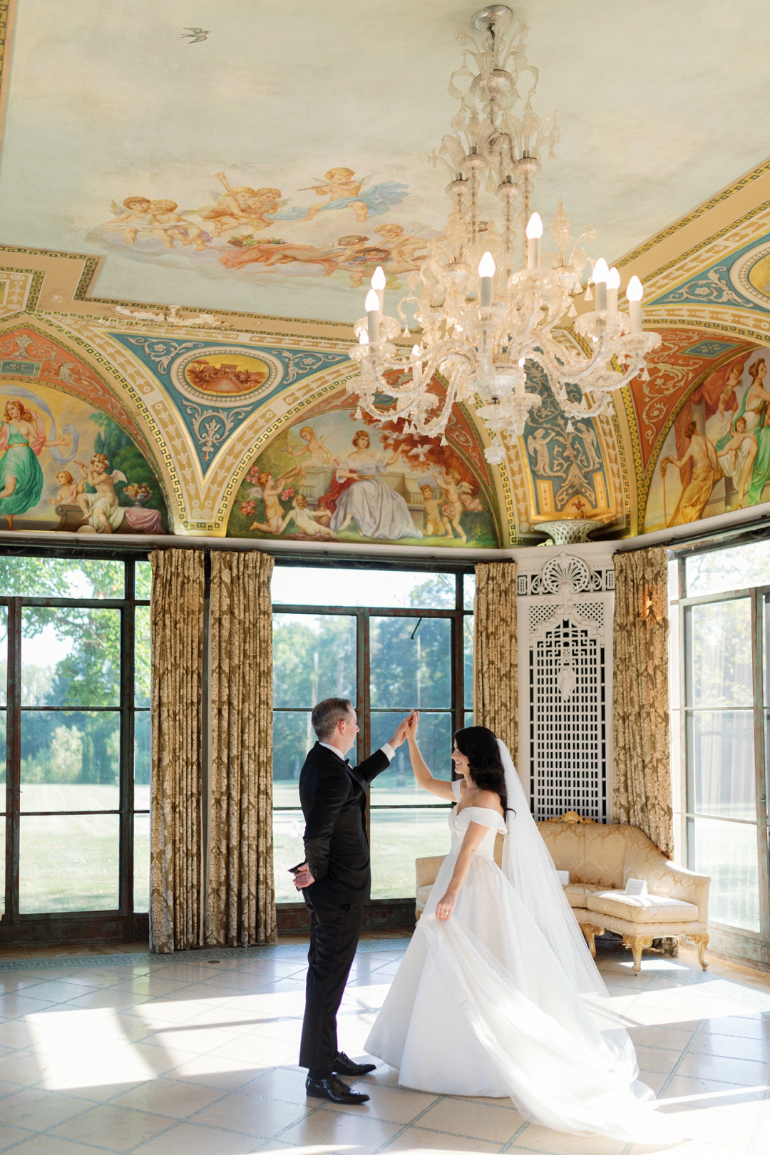 Bride and Groom dancing in a grand ballroom in natural light for fanara photographys wedding portfolio