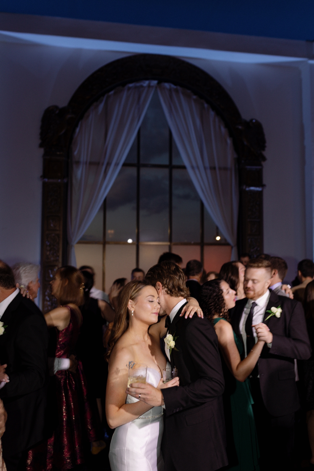 Direct flash wedding dance floor photo with guests celebrating in St. Louis
