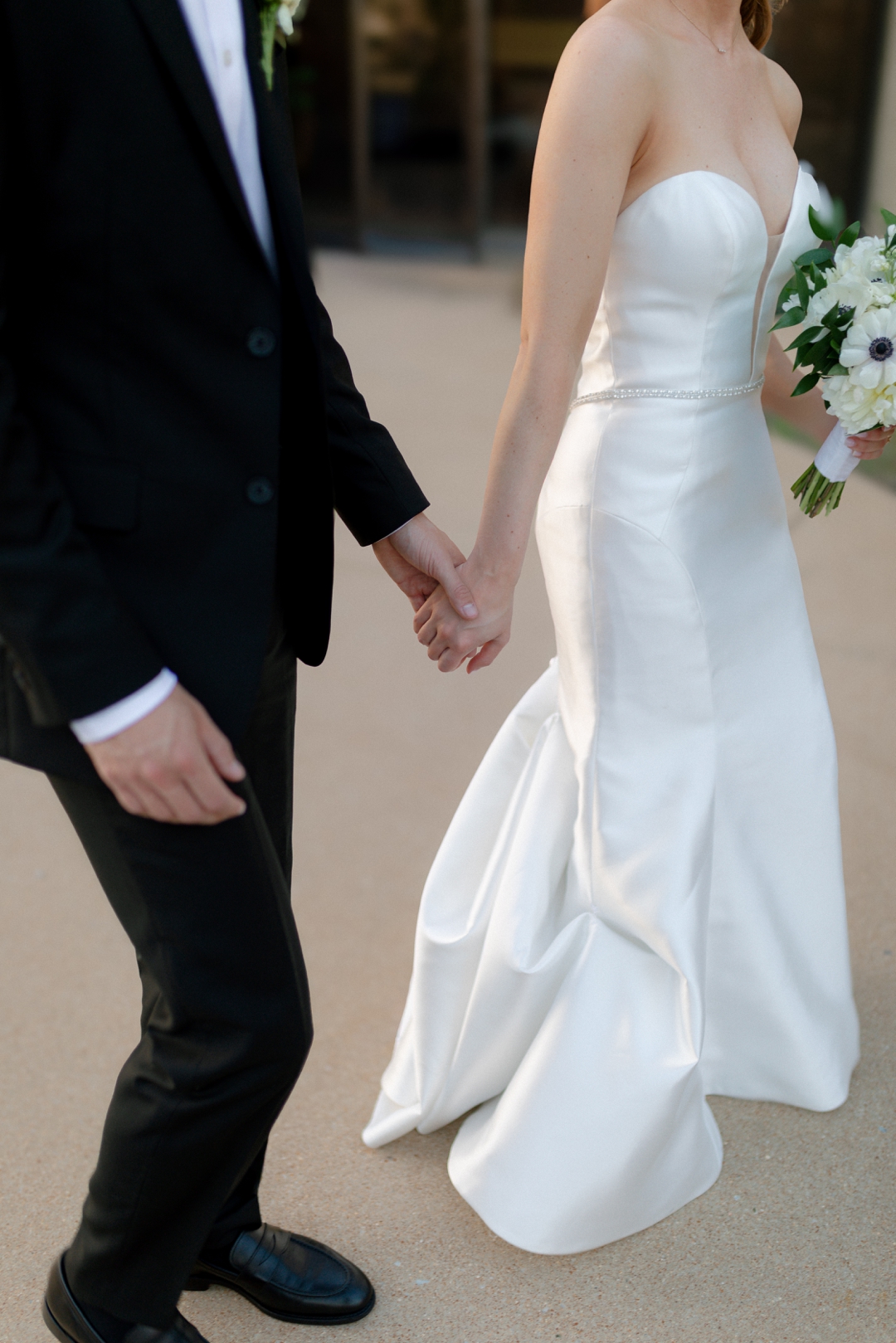 Newlyweds walking together between wedding events