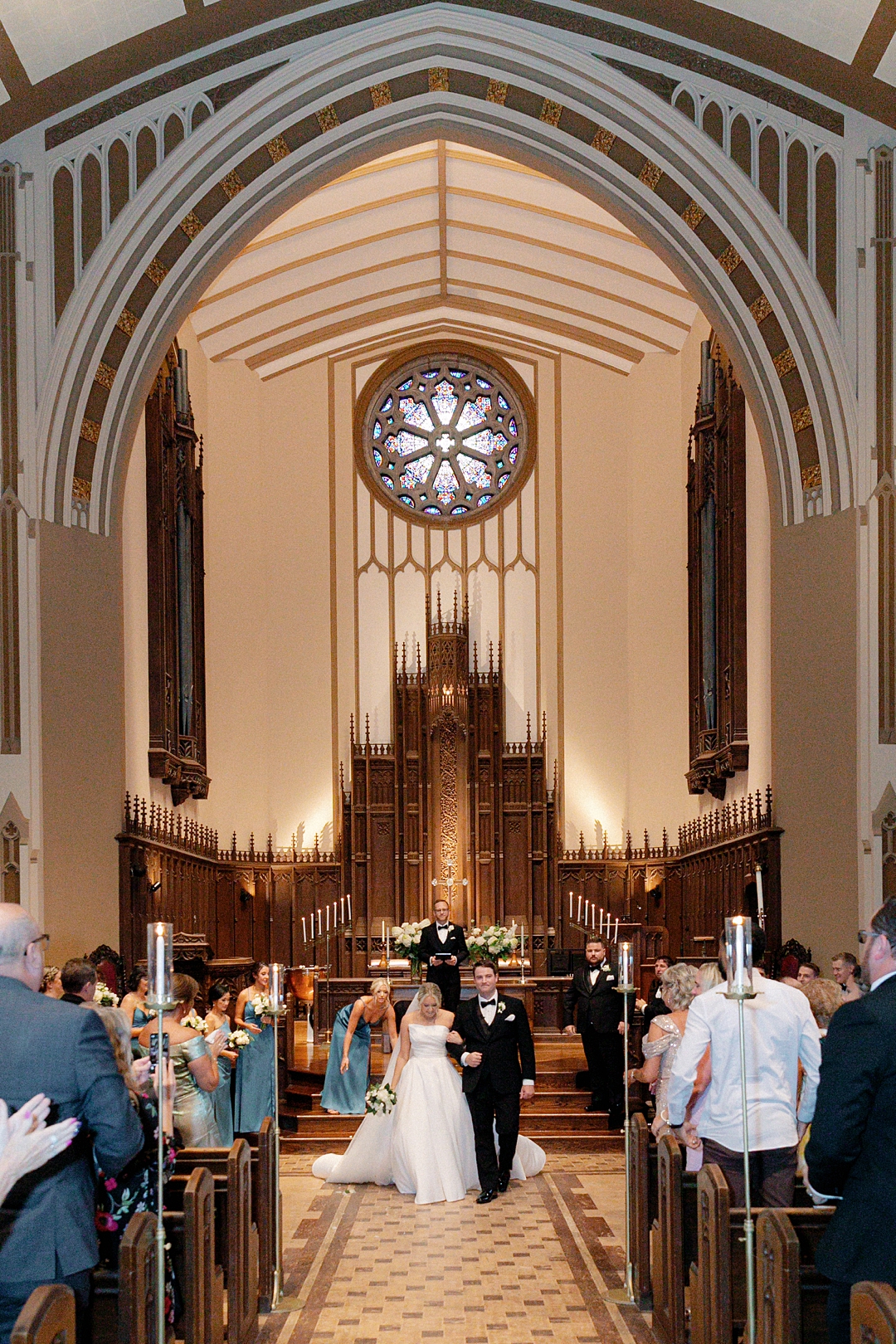 Bride and groom just married walking down the church aisle
