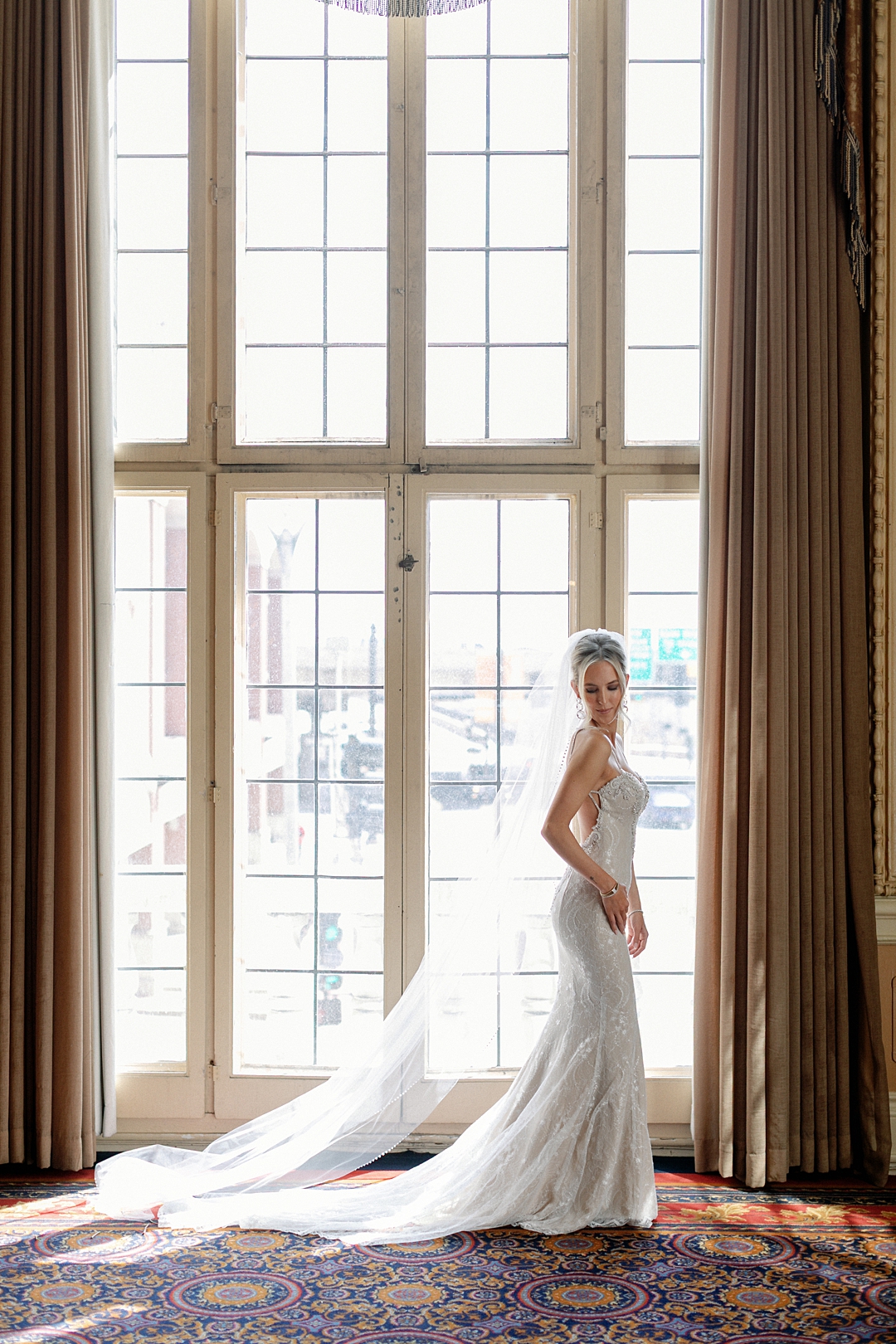 Deane standing beside a tall window inside the Missouri Athletic Club
