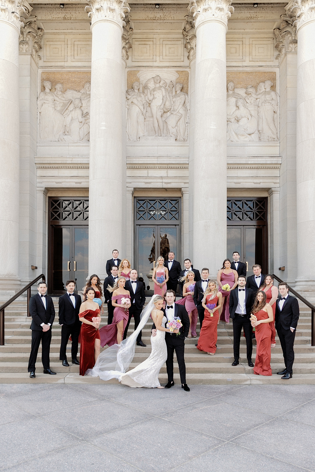 Colorful wedding party on the steps of the St. Louis Art Museum