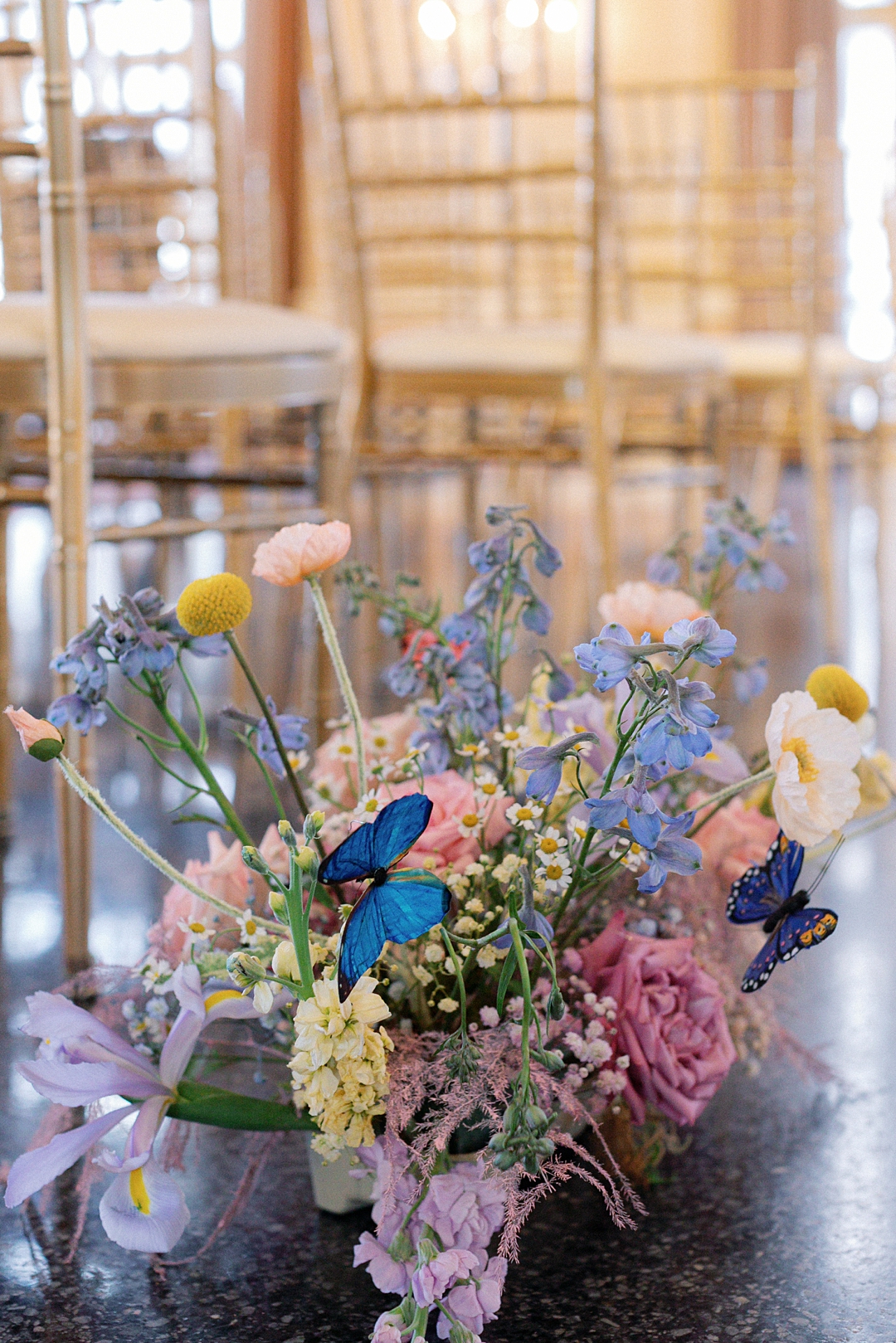 Colorful spring florals with butterfly details at the ceremony