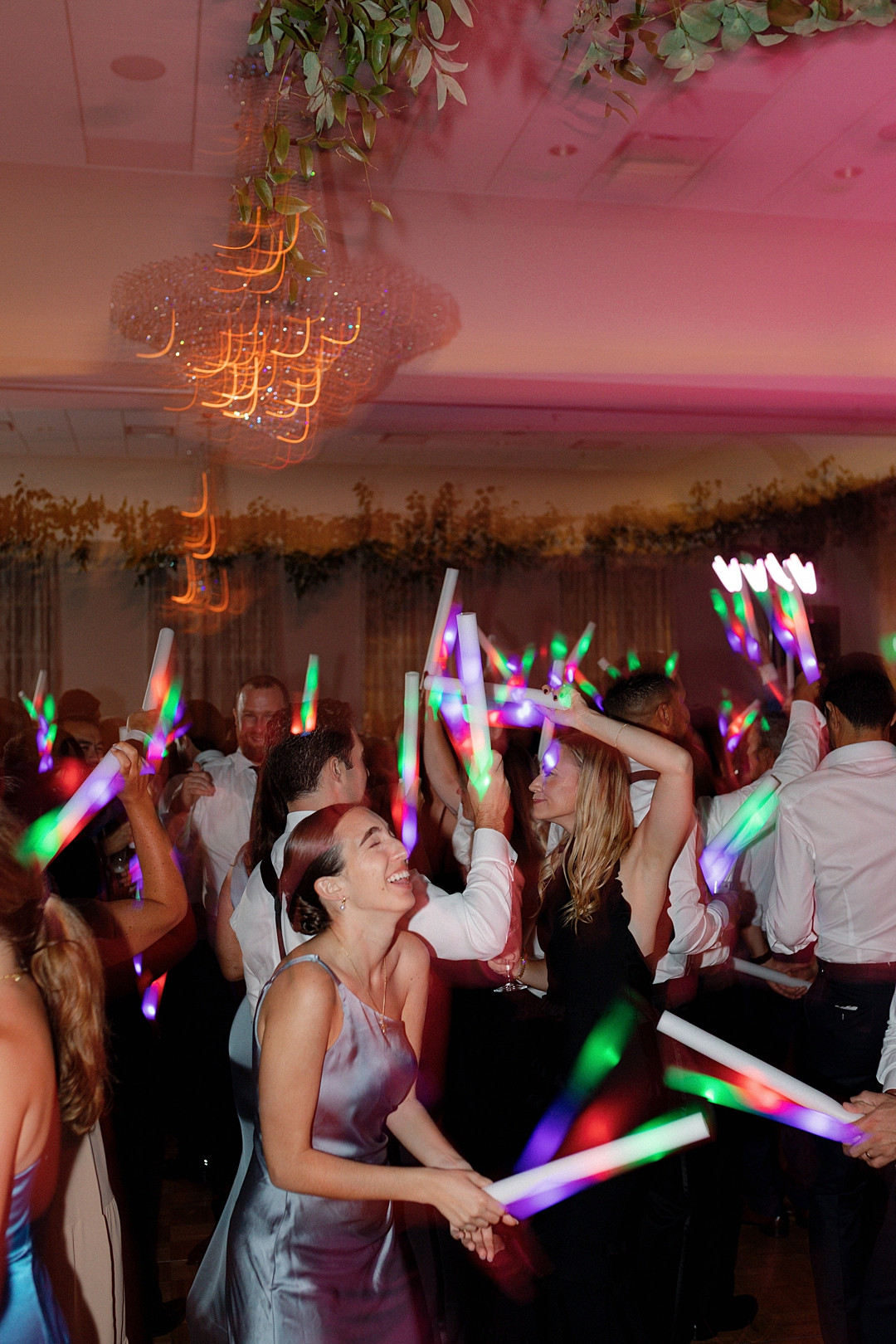 Wedding dance floor celebration with dramatic lighting