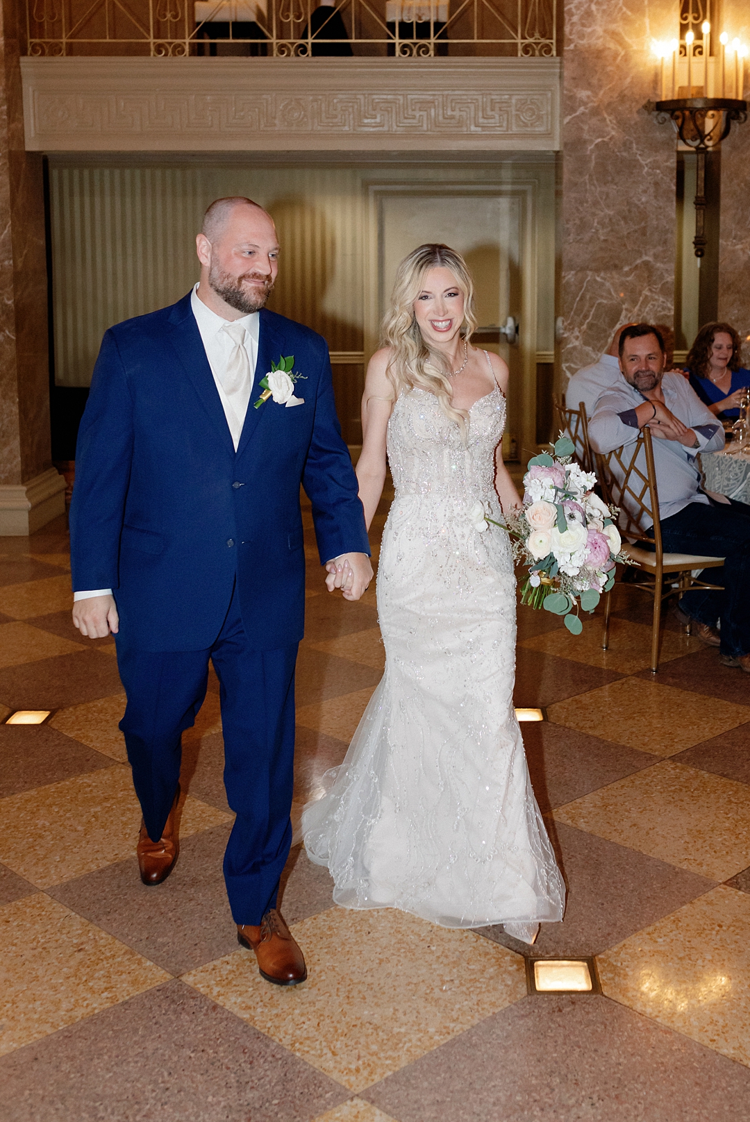 Guests seated inside a warmly lit St. Louis wedding reception