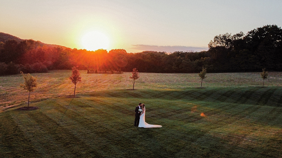 Couple portrait at sunset in an open field