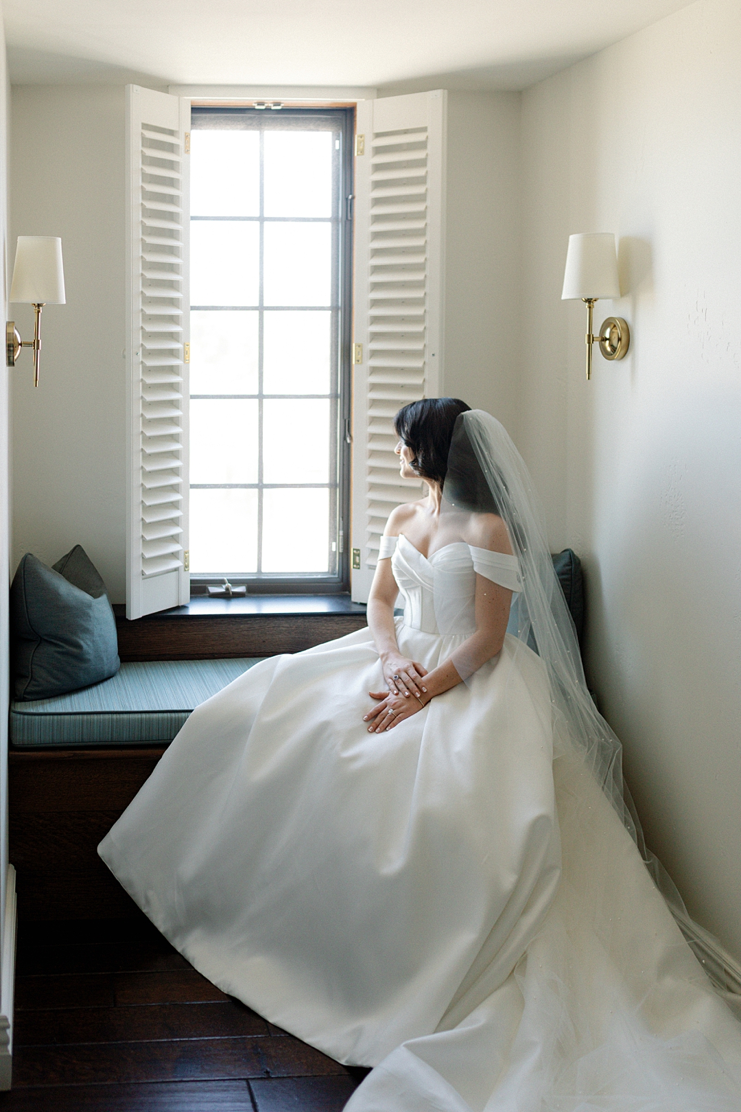 Bride portrait in soft window light with editorial wedding styling and mood