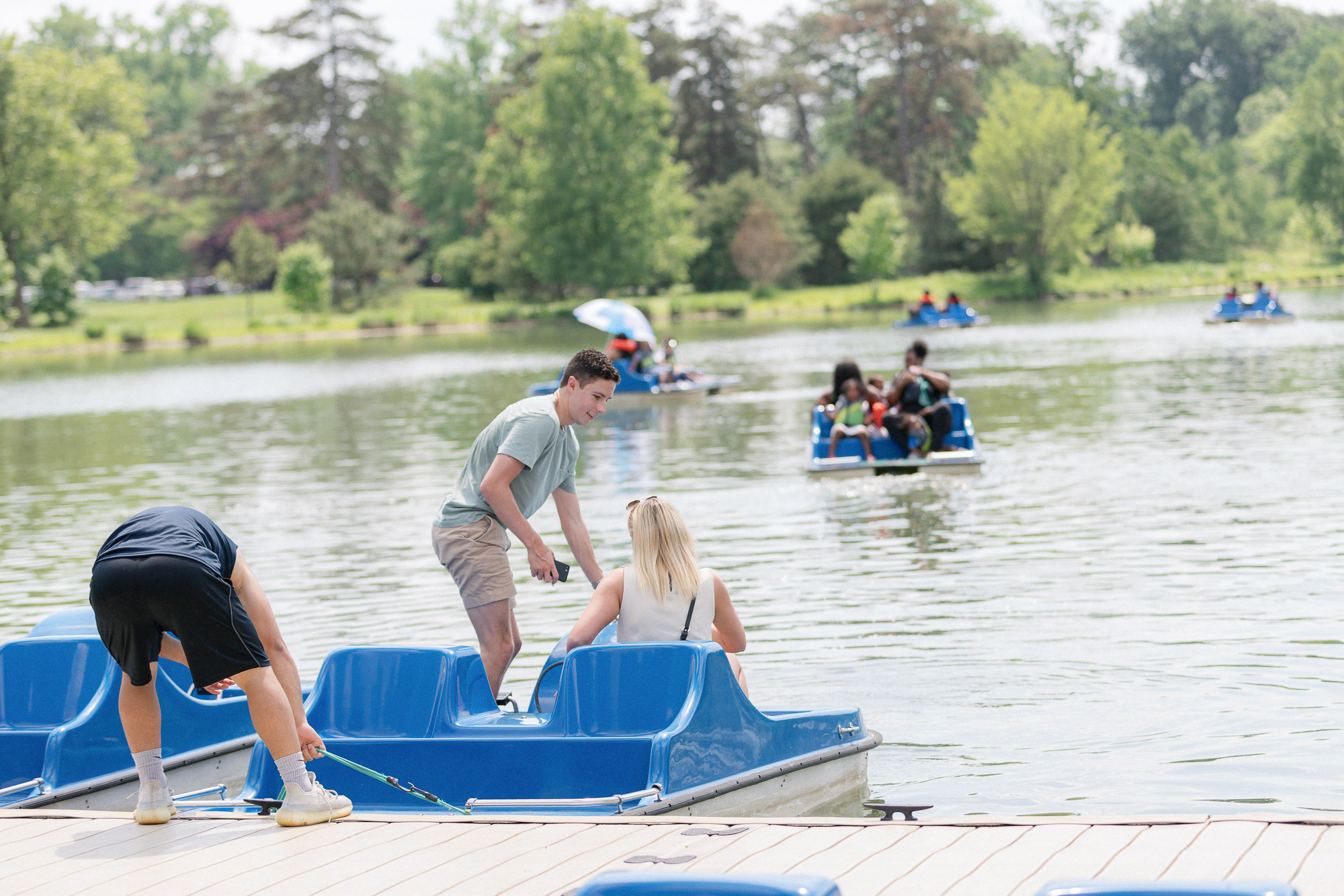 Couple stepping off the paddle boat at Forest Park in St. Louis after the proposal