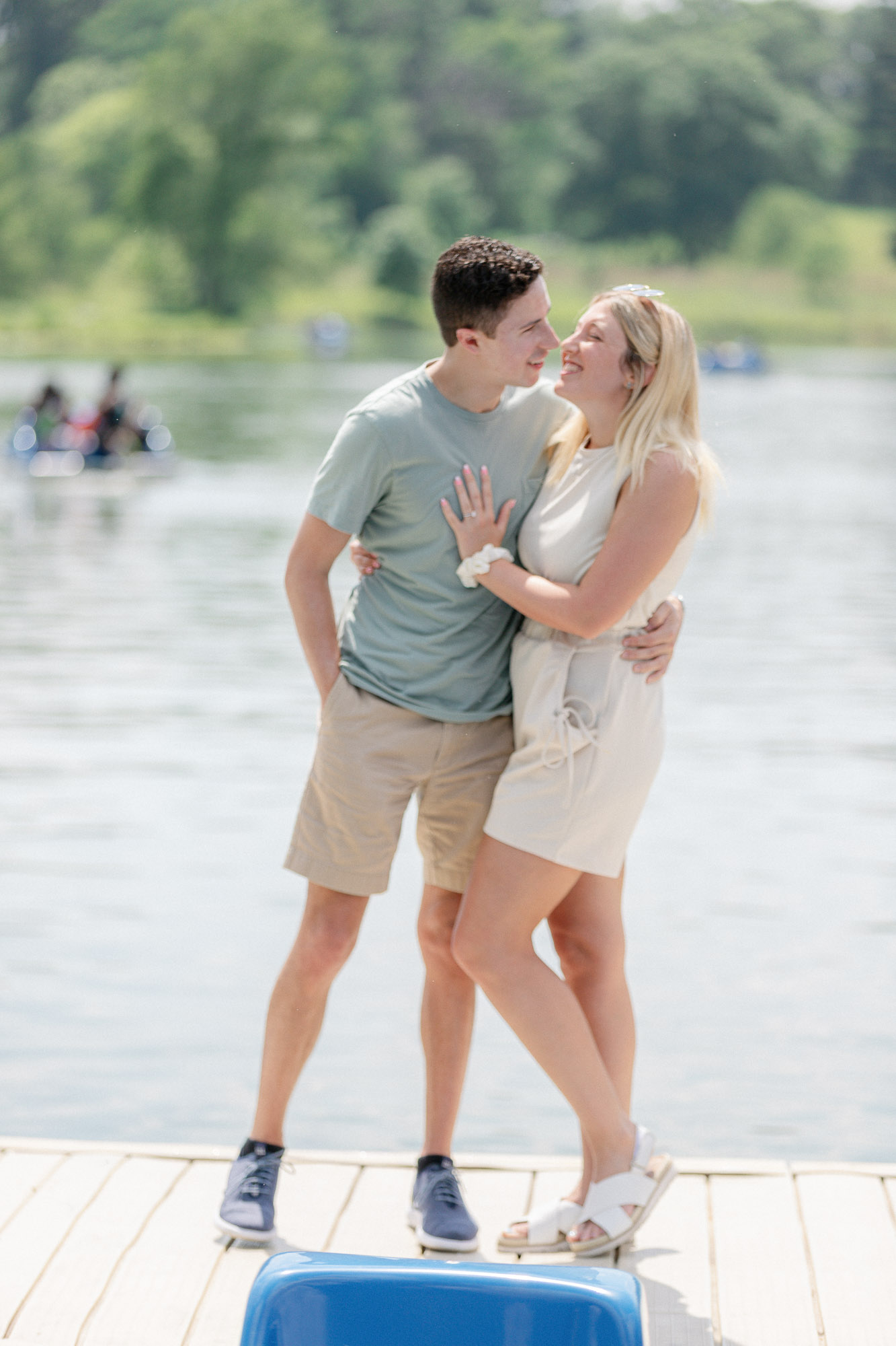 Newly engaged couple standing together on the dock after their Forest Park proposal in St. Louis