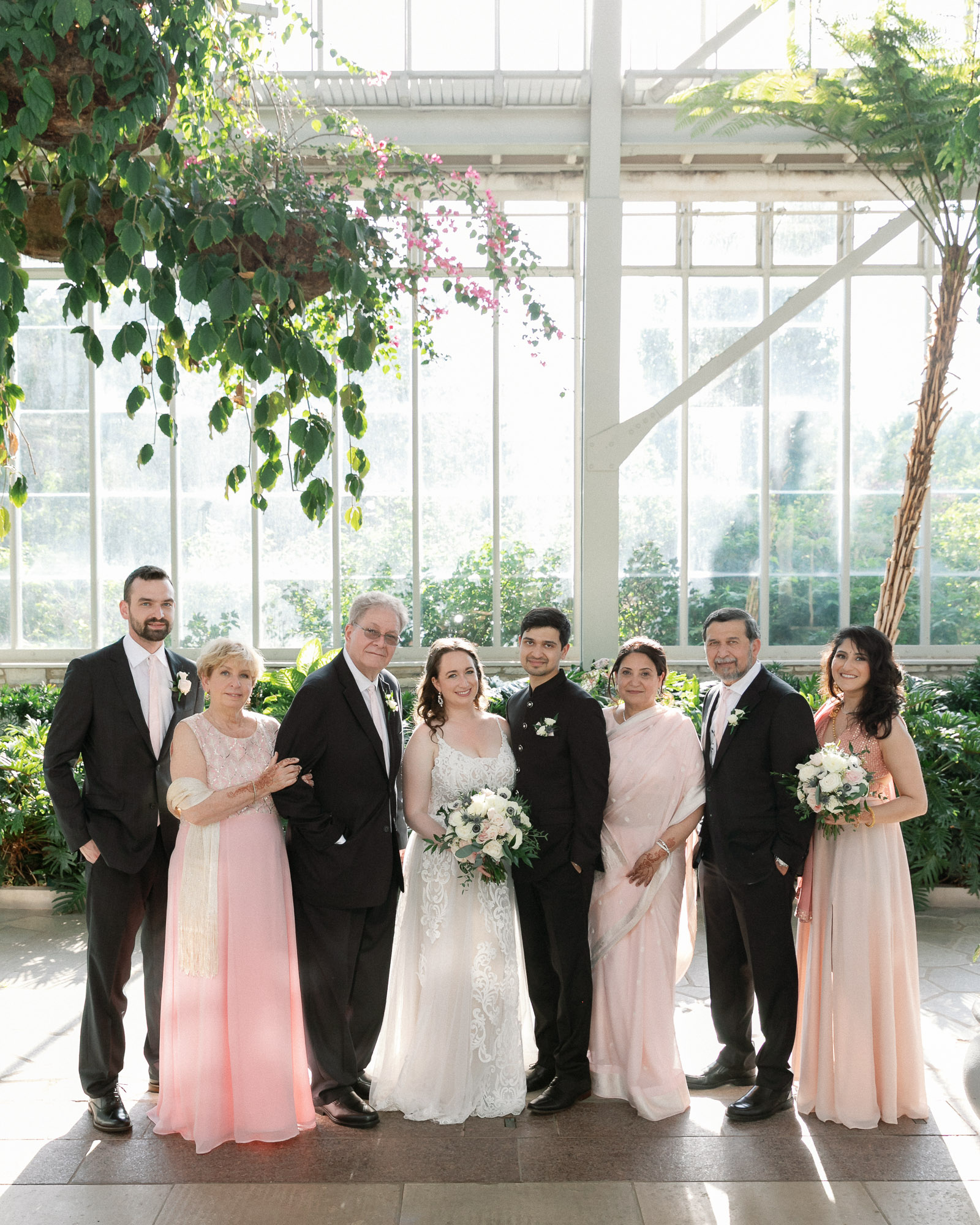 Wedding portrait in a glass venue with clean structure and soft natural light