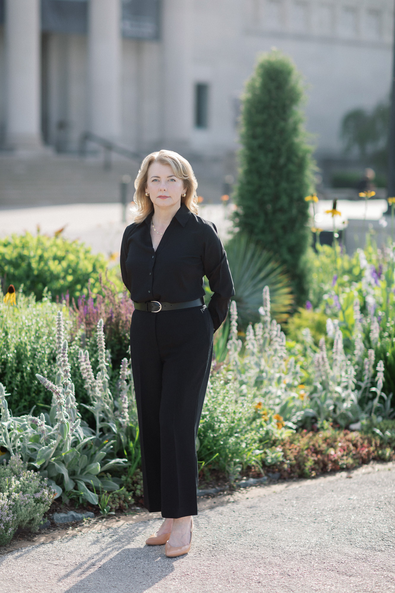 Full length outdoor professional headshot of a woman in black in Forest Park