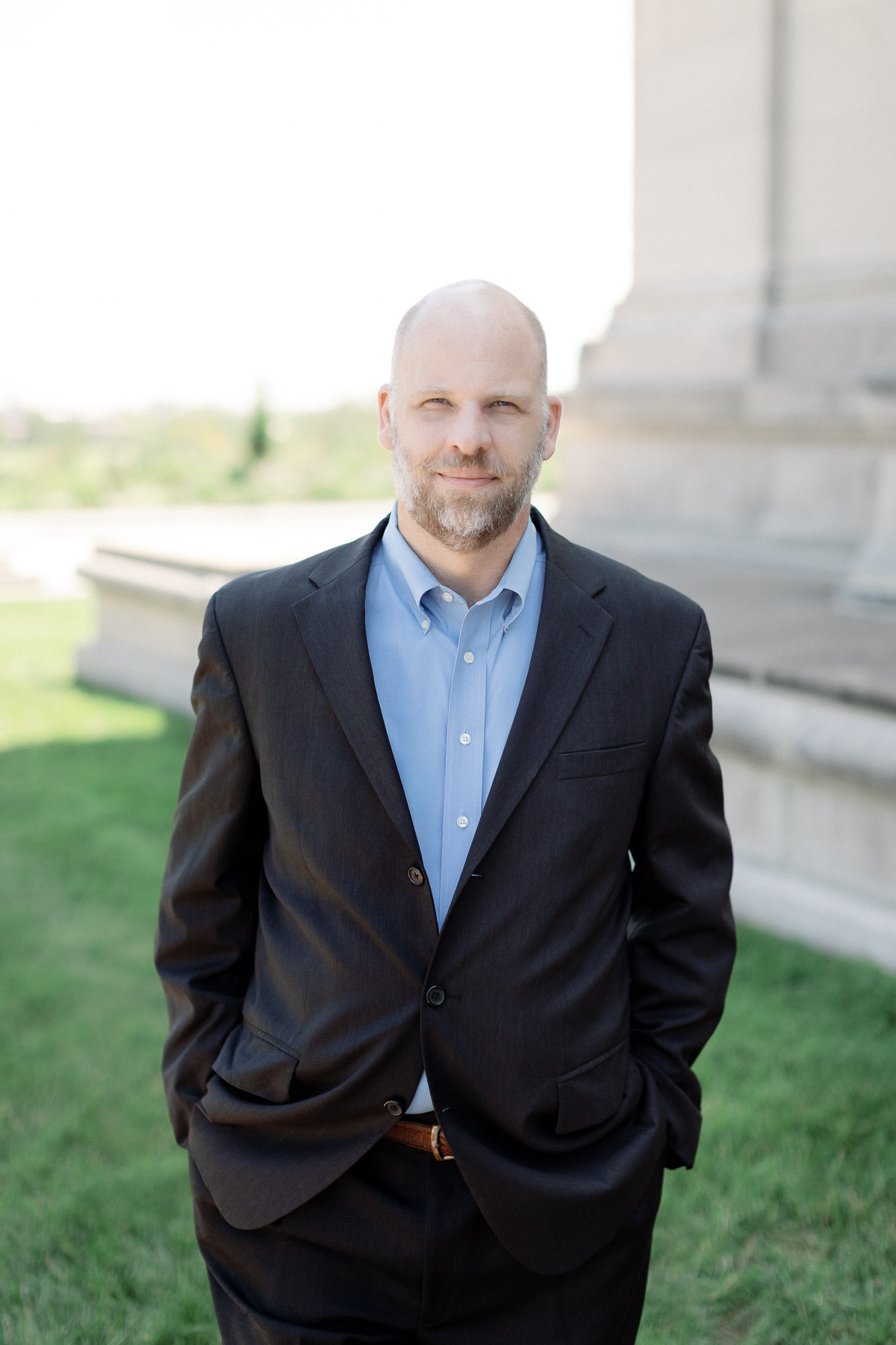 Professional outdoor headshot of a man in a blazer in Forest Park in St. Louis