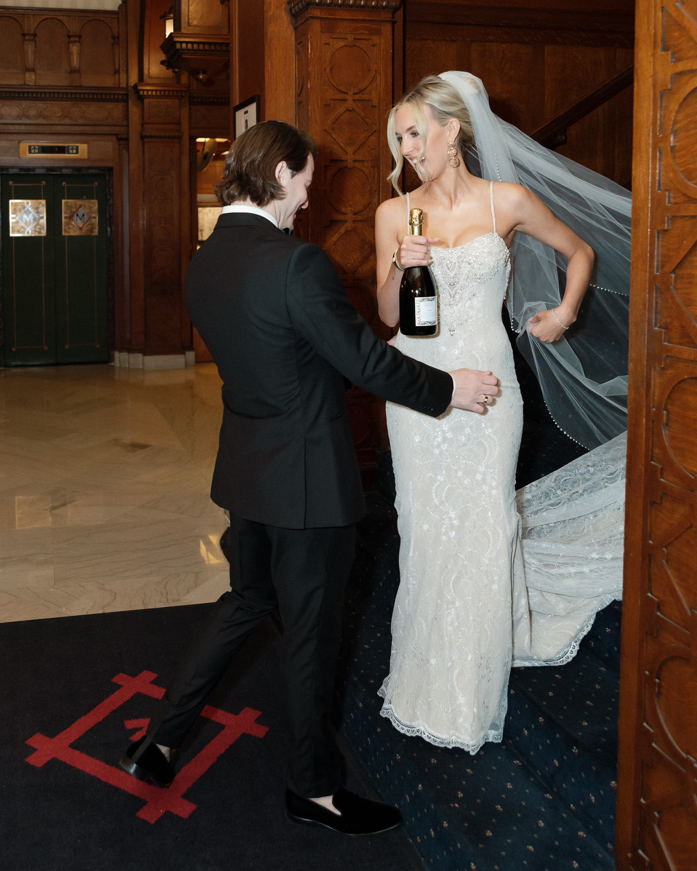 Bride laughing during champagne first look photos