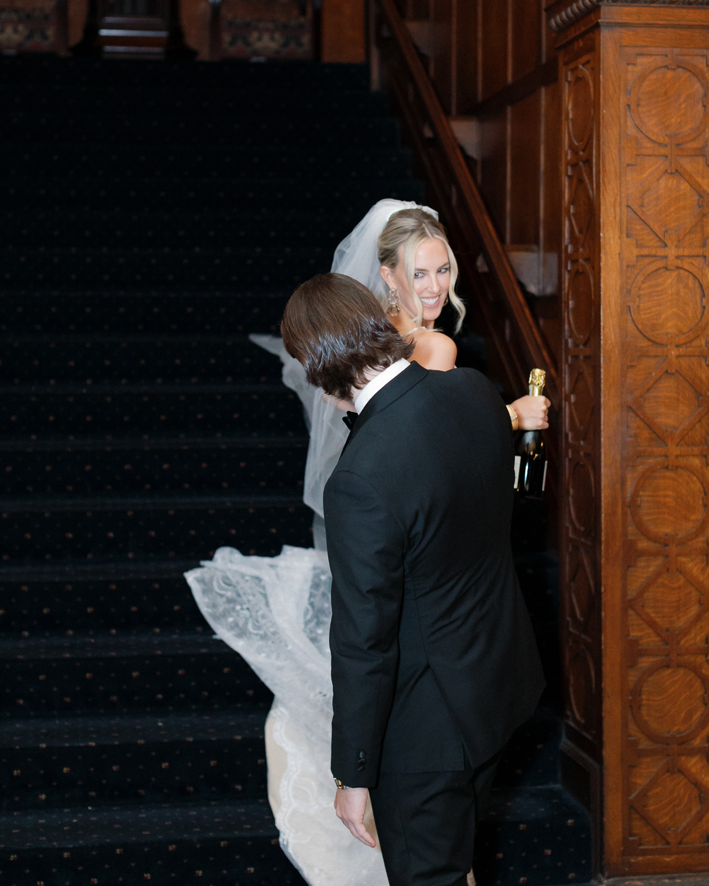 First look portrait with champagne bottle at the Missouri Athletic Club wedding