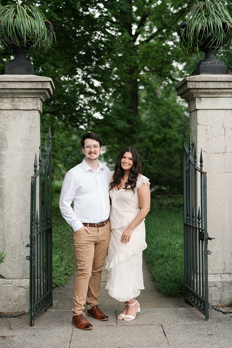 Elise and Hayden standing together at the garden gate