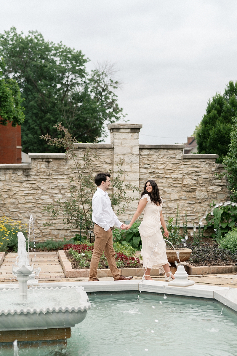 Elise and Hayden walking beside the fountain at the Missouri Botanical Garden