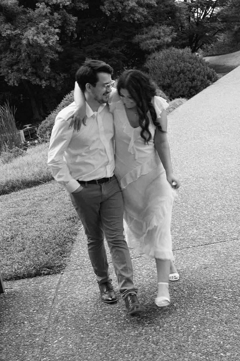 Black and white photo of Elise and Hayden walking together at the Missouri Botanical Garden