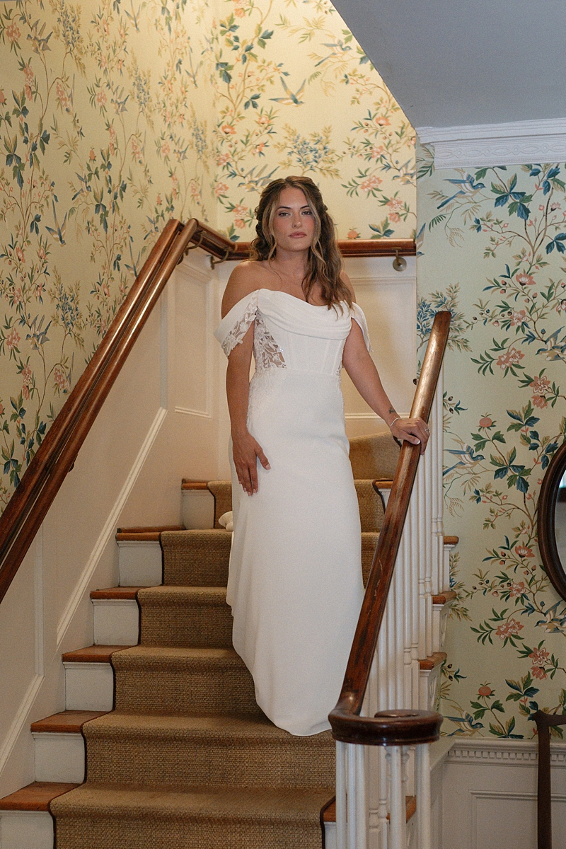 Haile standing on the staircase inside Legare Waring House