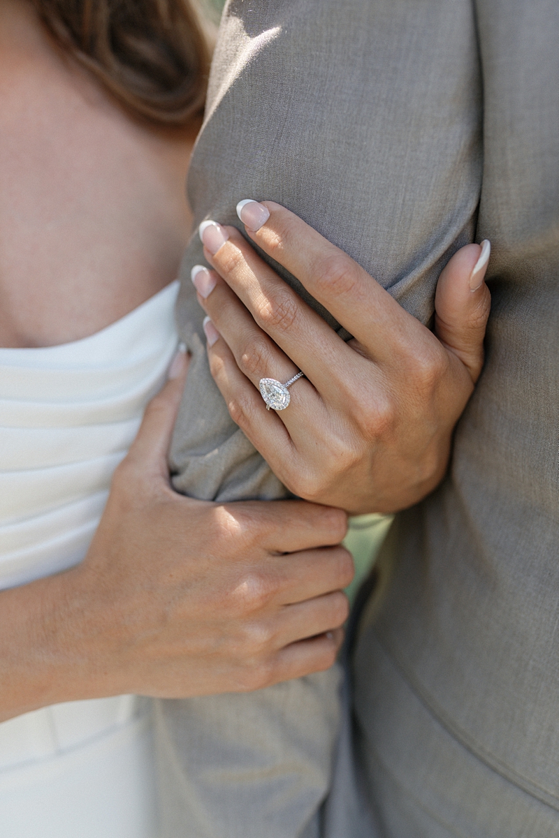Haile’s pear-shaped engagement ring against Clayton’s suit