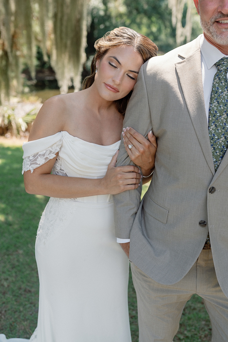 Haile resting her head on Clayton’s shoulder beside the lagoon