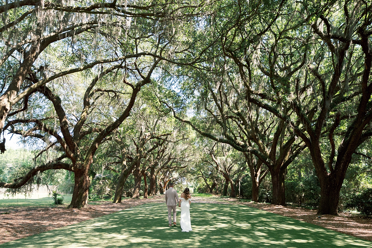 Haile and Clayton walking beneath the Avenue of Oaks at Legare Waring House