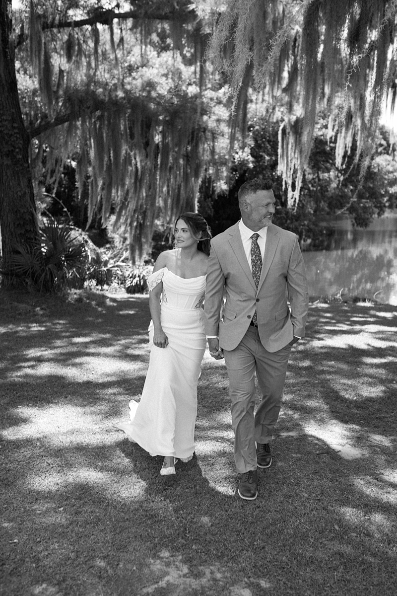 Haile and Clayton walking beneath Spanish moss at Legare Waring House