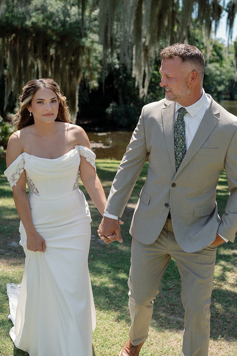 Haile and Clayton walking together beside the lagoon at Legare Waring House