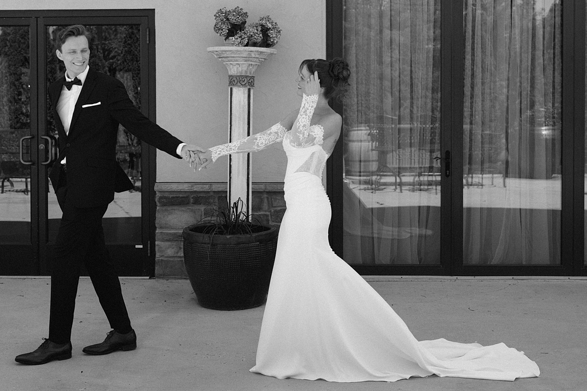 Luke leading Katie by the hand during their wedding portraits