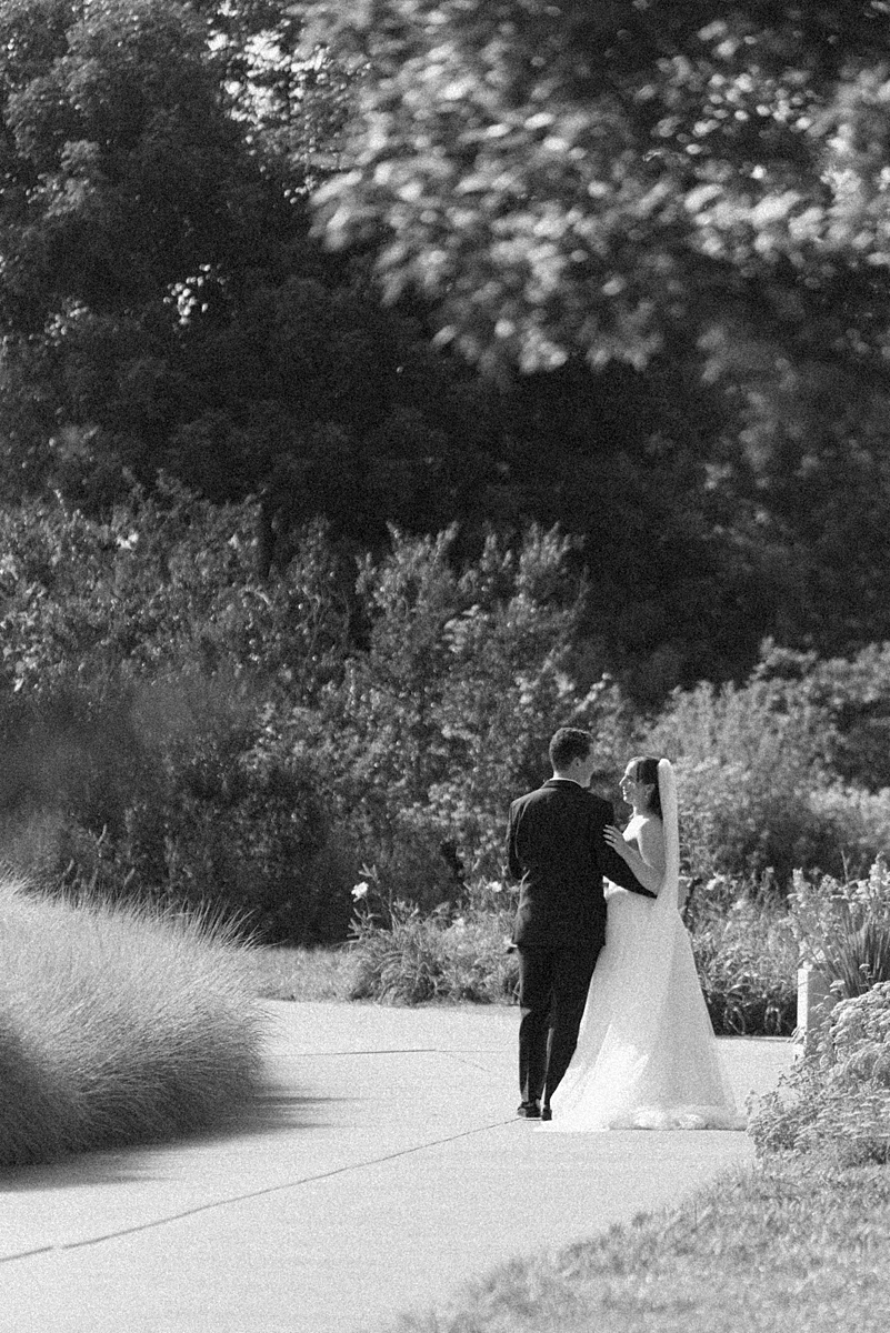 Black and white photograph of Jill and Dylan walking through Forest Park