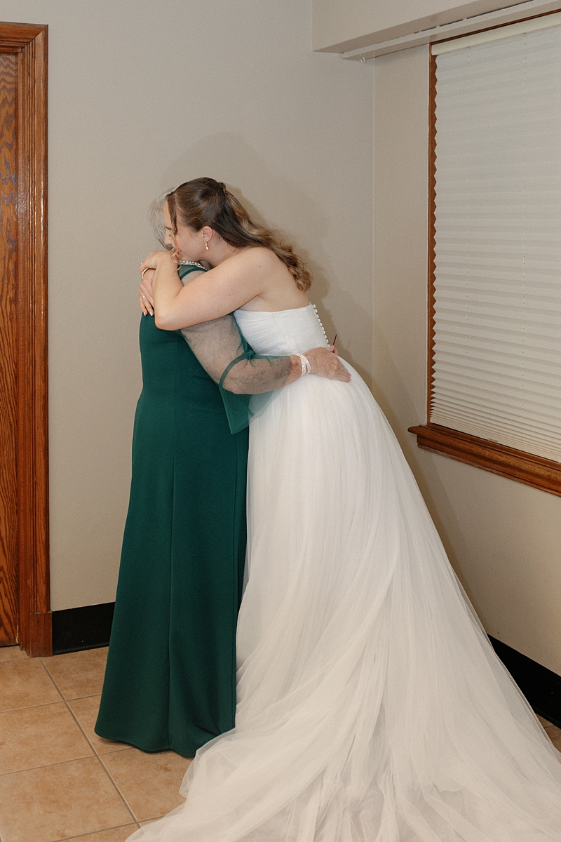 Jill hugging her mom before her St. Louis wedding ceremony